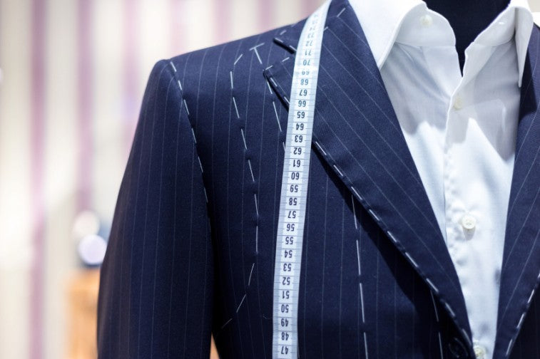 Tailored wool suits hanging on display