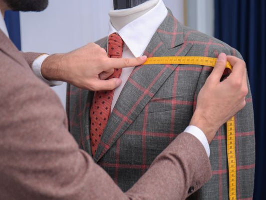 Tailor working on the construction of a suit jacket
