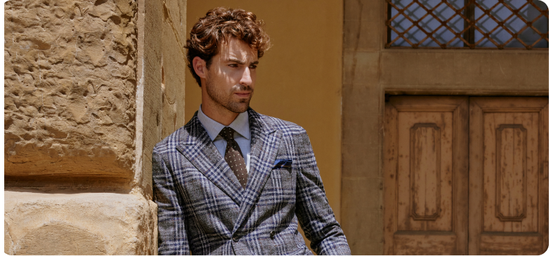 A blue double-breasted bespoke suit by Mr James, fastened on the lower row with the lapels rolling down to the waist