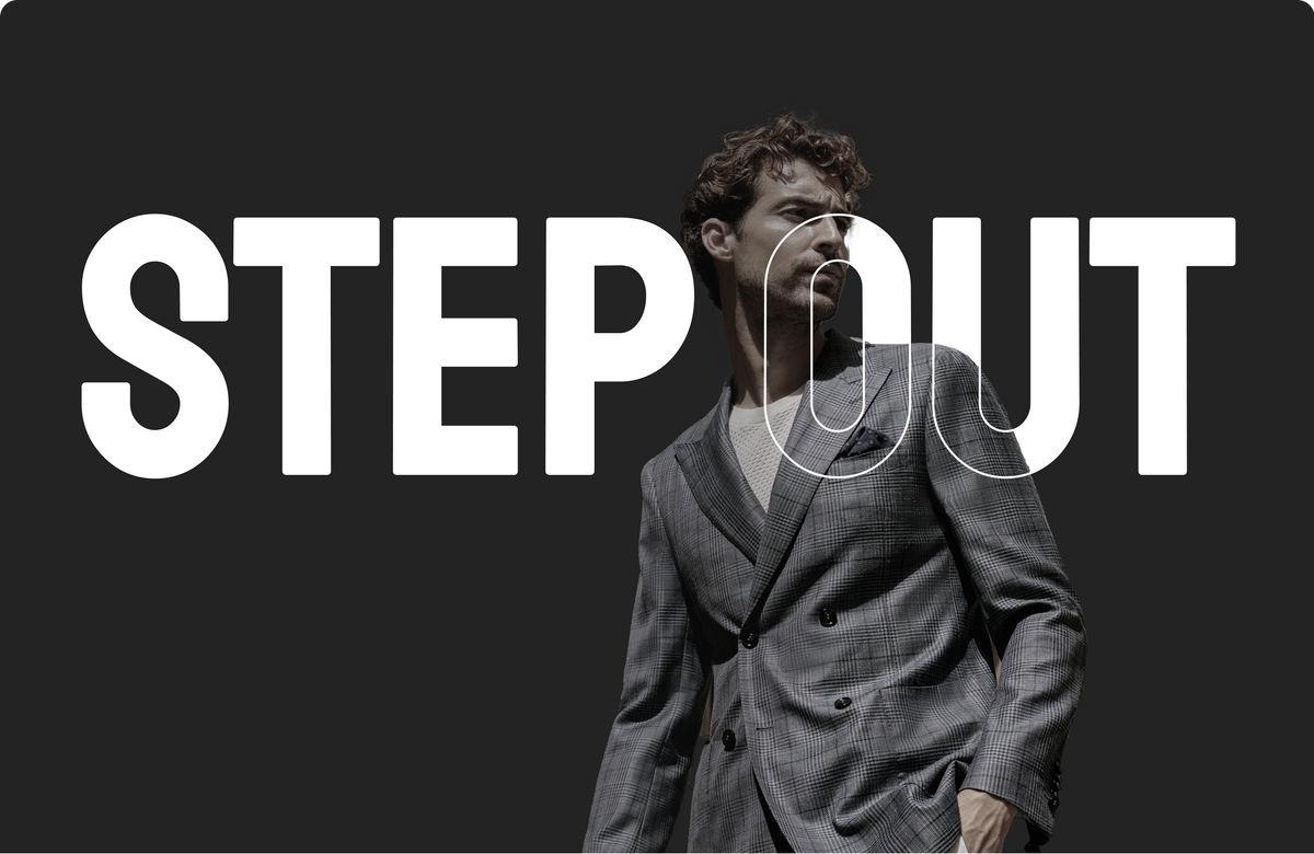 Man in a tailored grey suit stepping through the words Step Out